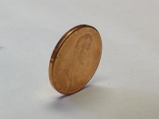 A penny balance up on its side